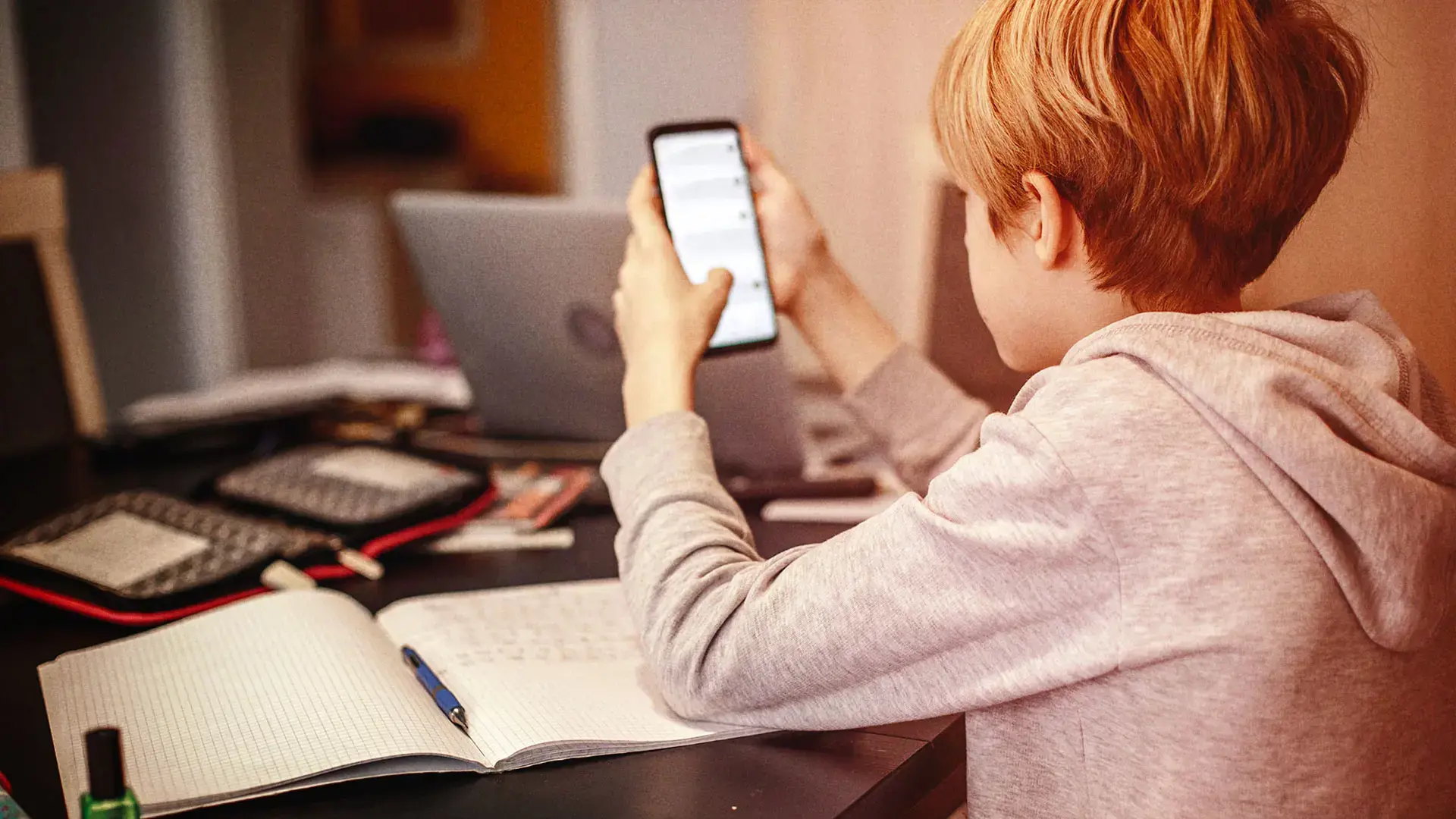 Young boy looking at a mobile phone