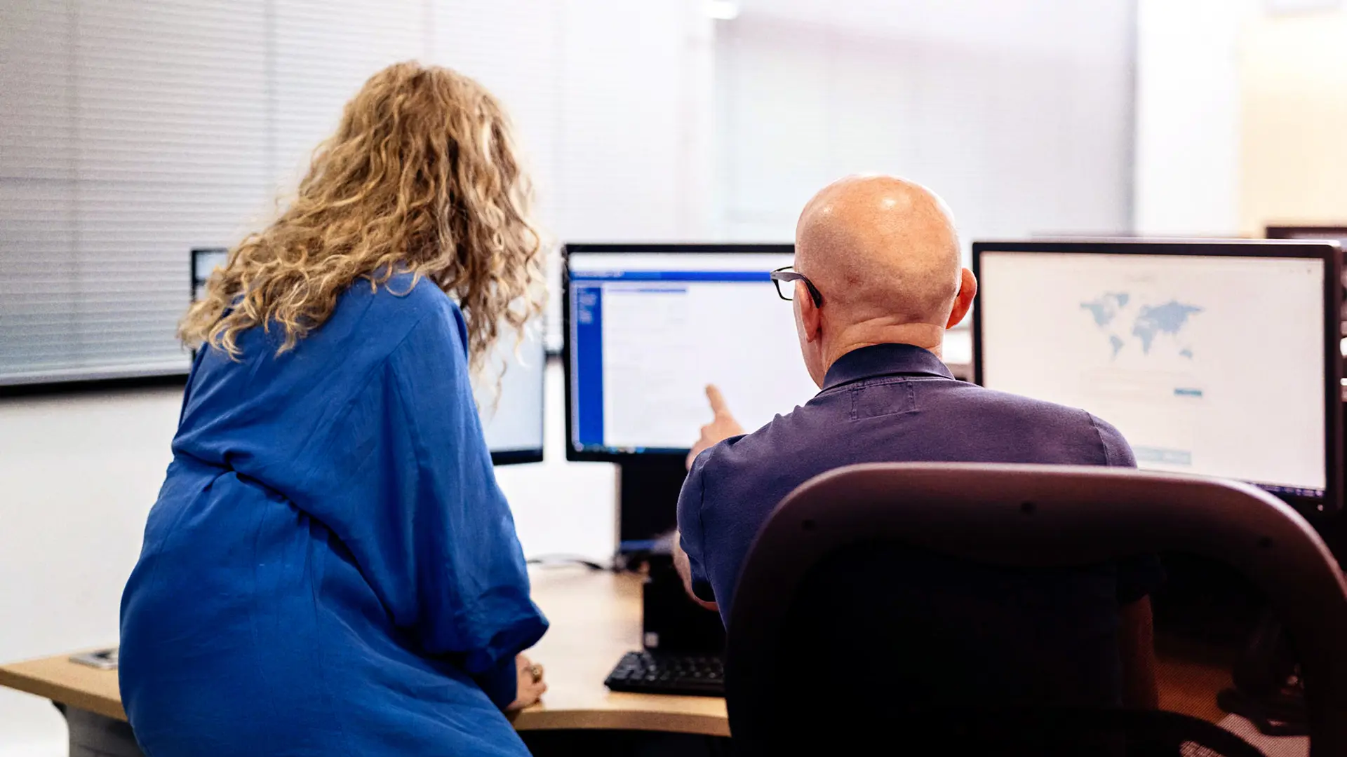 IWF Analysts working at a computer