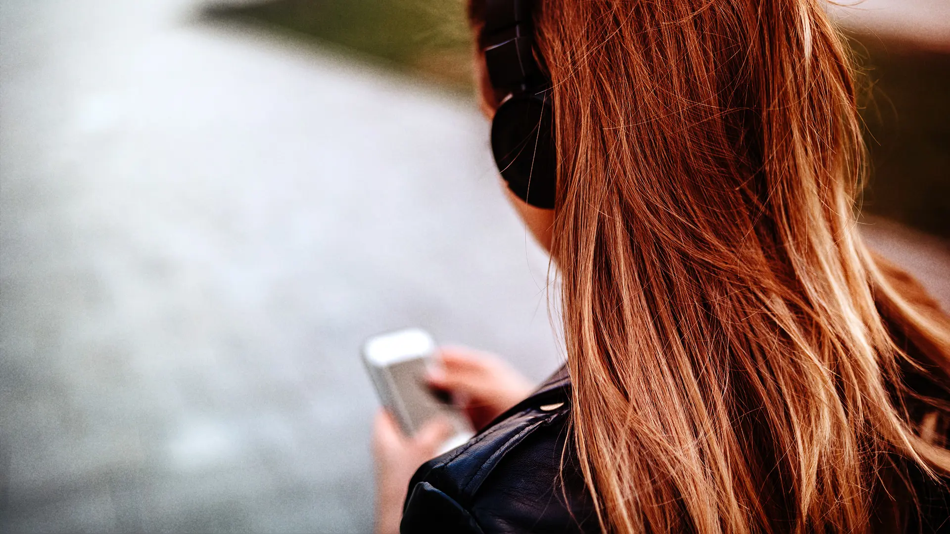 Woman with headphones listening to podcast