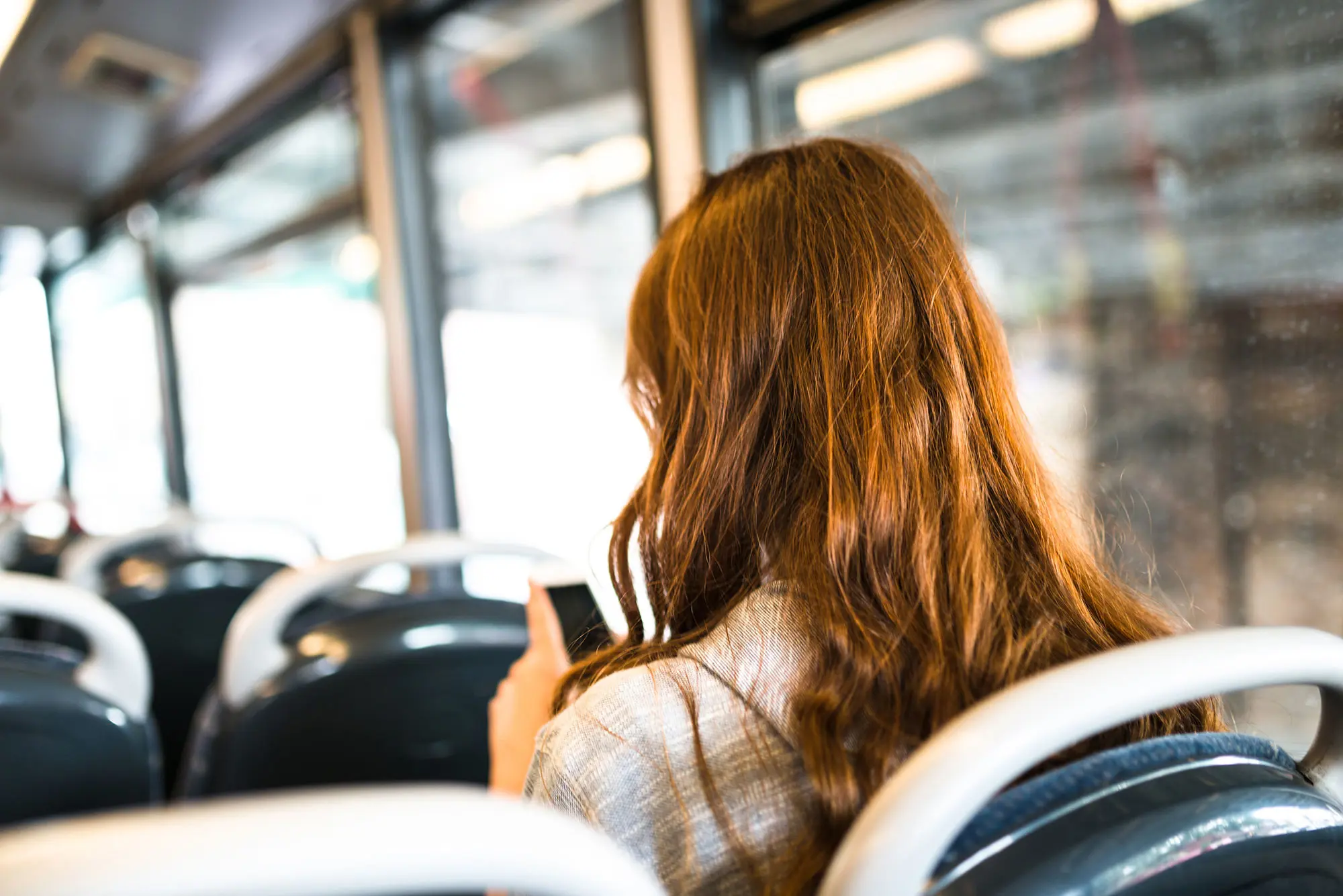 Report Remove Girl on Buss Looking at Phone