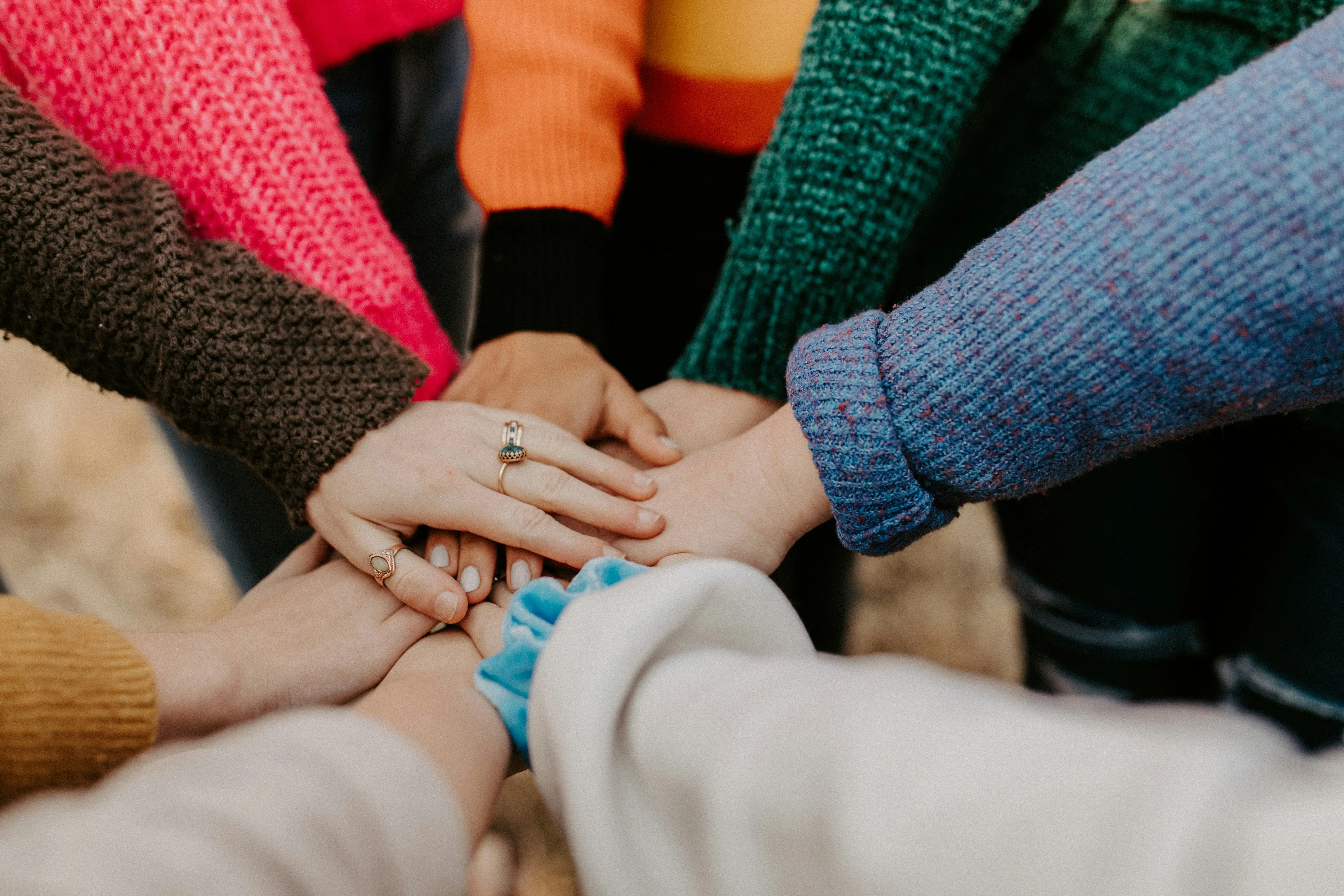 People placing their hands in a circle