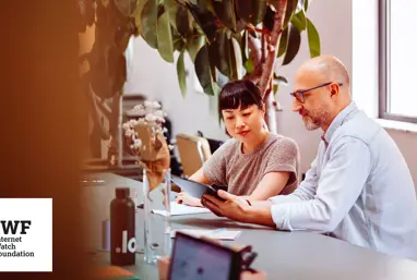 A discussion between two colleagues in an office