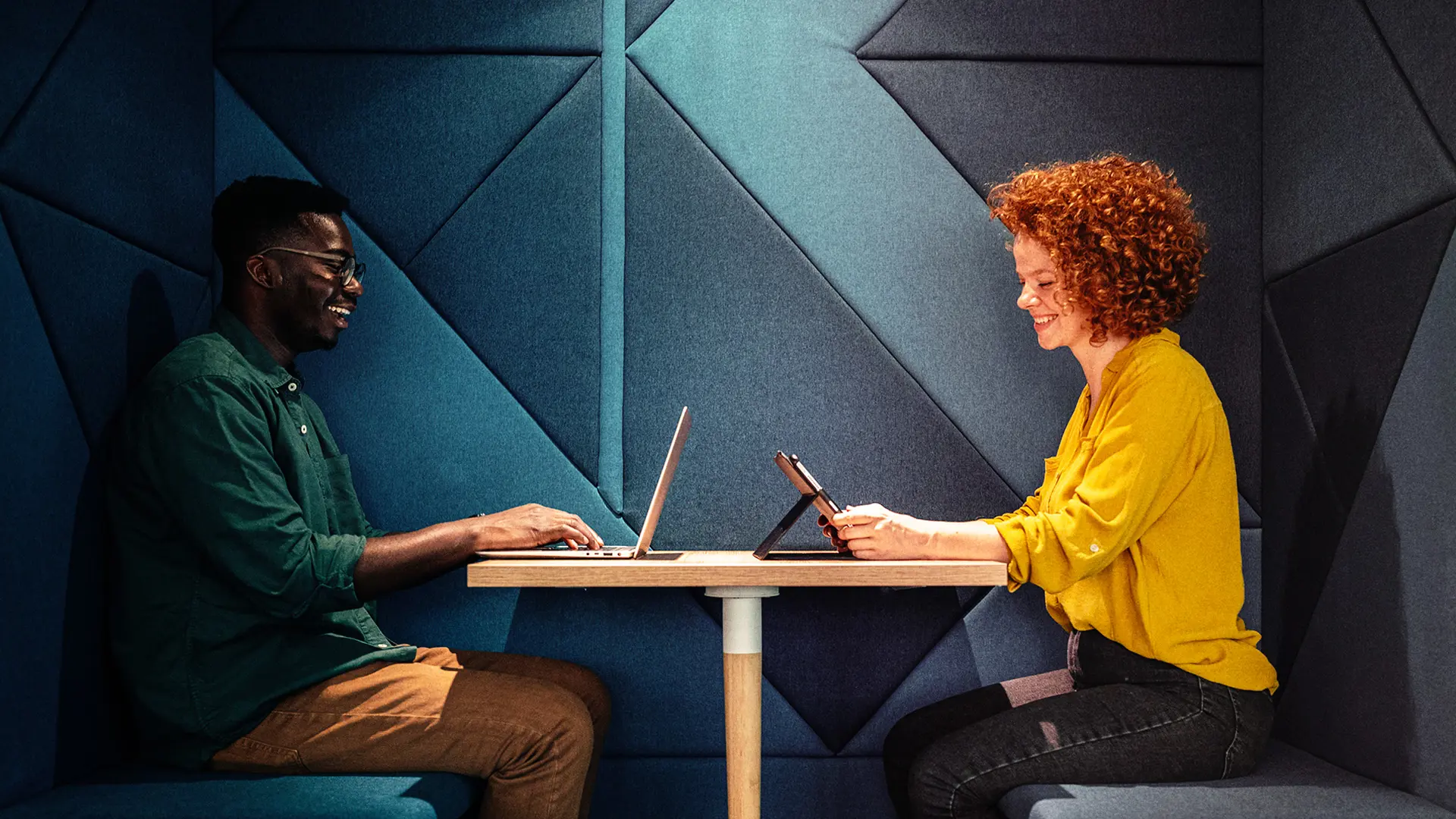 Man and woman working at a desk 