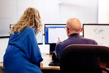 IWF Analysts working at a computer