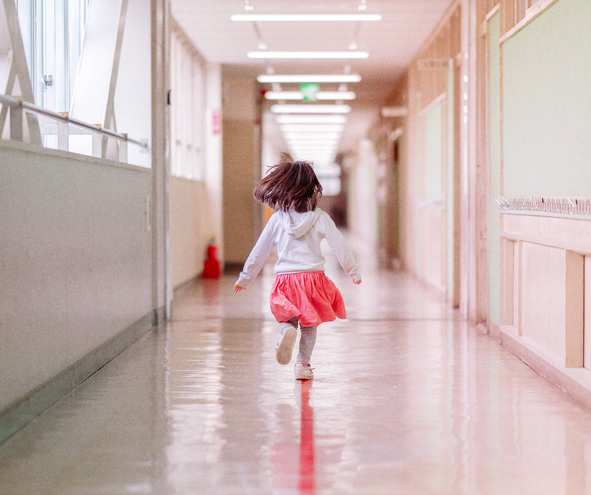 Girl running in school corridor